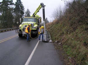 WSDOT operators vacuum sediment and debris from a roadside catchbasin using a vactor truck. Image courtesy of WSDOT